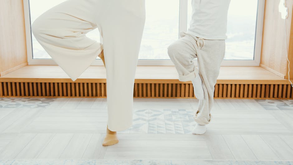 Woman practicing yoga on a mat in a bright minimalist room looking calm